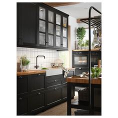 a kitchen with black cabinets and wooden counter tops is featured on the cover of ikea's catalogue