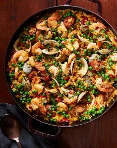 a skillet filled with seafood and peas