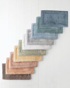 six towels hanging on the wall in different colors