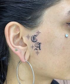 a woman with tattoos on her face and ear