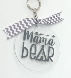 a clear keychain with the words mama bear on it and an arrow in the middle