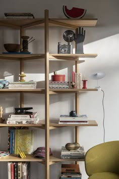 a yellow chair sitting in front of a bookshelf