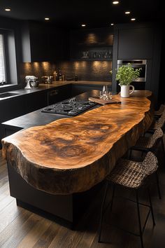 a large wooden counter in a kitchen next to a stove top oven and sink with chairs around it