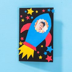 a card with an image of a child's face on a rocket ship