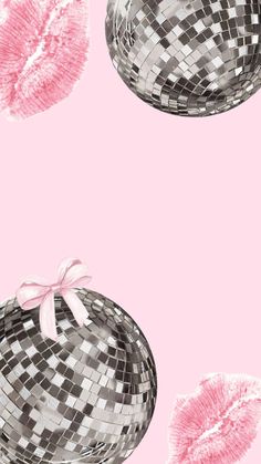 a pink and black background with silver disco ball hats on it's sides, one in the middle