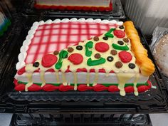 a cake that looks like a slice of pizza with toppings on it sitting on top of an oven