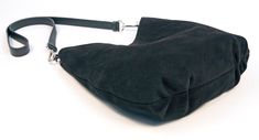 "This beautiful and luxuriously soft suede hobo bag will be a fashionable and chic addition to any ensemble. Crafted from a premium calf suede and fully lined with cotton canvas. This bag also features (2) interior 7\" zipper pockets, crossbody or shoulder strap, snap closure, pleats on bottom, silver hardware and hand painted edges. Handmade in Denver, CO. USA Dimensions: Width at widest- 14\" Height at tallest- 13\" Weight- 1 lb. 9 oz. Not finding exactly what you want? Sean Ray can make it fo Chic Suede Bucket Bag With Removable Pouch, Chic Suede Hobo Bag With Leather Handles, Chic Suede Hobo Bag, Chic Suede Hobo Bag With Removable Pouch, Chic Suede Bucket Bag For Everyday, Chic Suede Bucket Bag With Suede Lining, Chic Suede Hobo Bag With Suede Lining, Modern Suede Hobo Bag With Leather Handles, Chic Leather Hobo Bag With Suede Lining