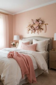 a bedroom with pink walls and white bedding