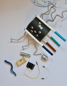 a group of different items that are laying on a table together, including an object made out of pencils