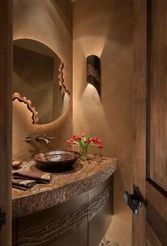 a bathroom with a sink, mirror and lights on the side of the wall next to it