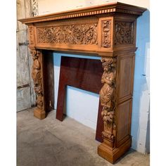 an old fireplace with carvings on the mantle