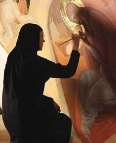 a woman is painting an angel on the wall