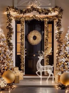 christmas decorations with gold and silver balls around the front door, including a deer statue