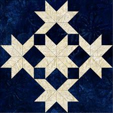 an image of a blue and white quilt with stars in the center on it's side