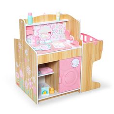 a wooden toy kitchen with pink appliances and flowers on the walls, in front of a white background