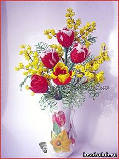 a vase filled with yellow and red flowers