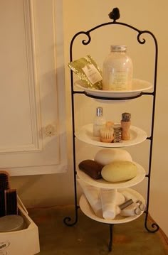 a three tiered shelf with soaps, shampoo and other items on it