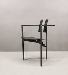 a black chair sitting on top of a white floor