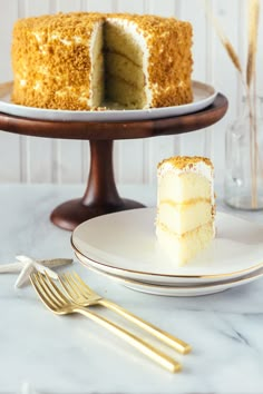 a cake on a plate with a slice taken out of it and the rest of the cake behind it