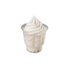 a cup filled with whipped cream on top of a white table