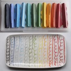 a white tray filled with lots of different colored paper