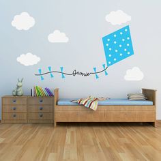 a room with a bed, dresser and wall stickers on the walls in it