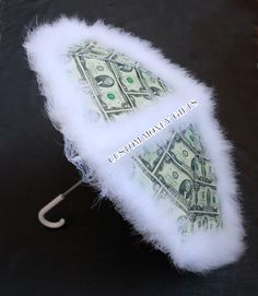 a dollar bill umbrella with white fur on it