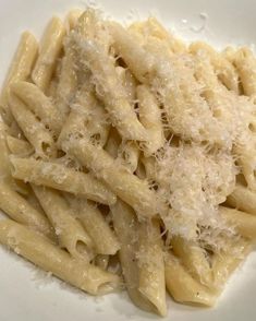 pasta with parmesan cheese on a white plate