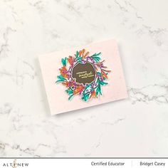 a greeting card with a floral wreath on it