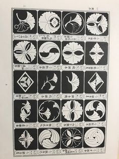 an old book with some black and white designs on the pages, all in different shapes