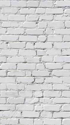 an old white brick wall textured with paint