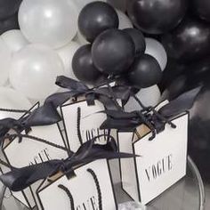 black and white party decorations with balloons in the background