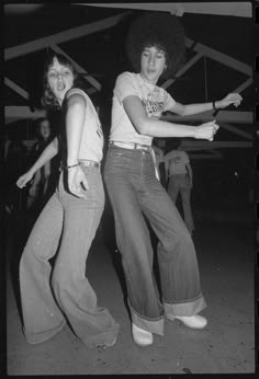 two young women are dancing on the dancefloor in an old black and white photo