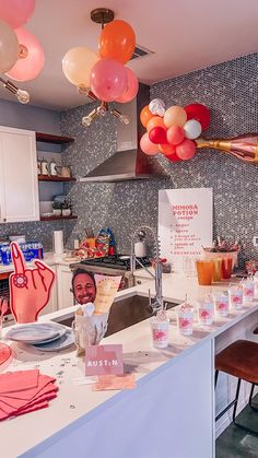 a kitchen with balloons hanging from the ceiling