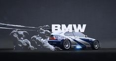 the bmw car is parked in front of a large screen with an advertisement on it