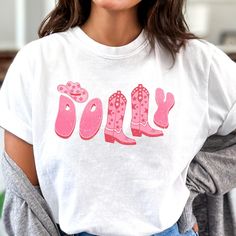 a woman wearing a t - shirt that says dolly with pink cowboy boots on it