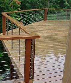 a wooden deck with metal rails and railings