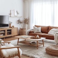 a living room filled with furniture and a flat screen tv on top of a wooden stand