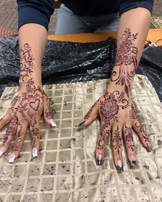 a woman with henna tattoos on her hands