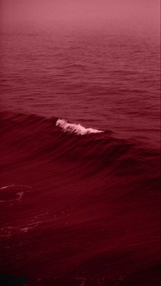 a person riding a wave on top of a surfboard in the middle of the ocean