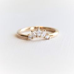 a gold ring with three diamonds on it