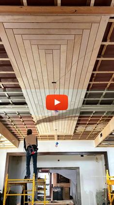 a man is standing on a scaffold in the middle of an unfinished room