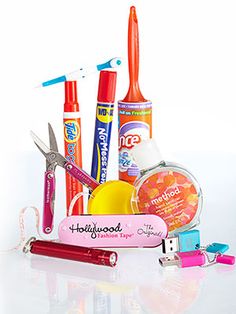 an assortment of toothbrushes, glue, and other items on a white surface