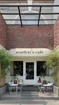 the front entrance to scarlett's cafe with chairs and tables outside