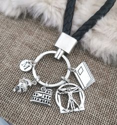 a close up of a key chain on a dog's neck with charms attached to it