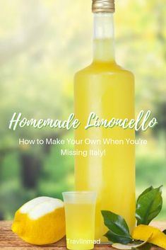 a bottle of lemonade sitting on top of a table next to some lemons