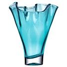 a blue glass vase sitting on top of a white table