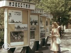 a woman standing in front of a bus stop