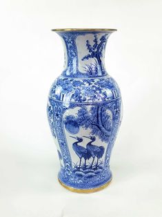 a blue and white vase with birds on it