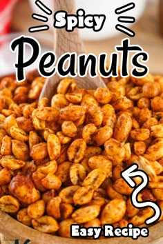 a wooden spoon full of peanuts with the words spicy peanuts easy recipe in front of it